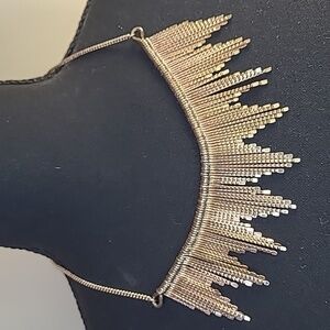 Gold tone dangly bib necklace. Full length 21"